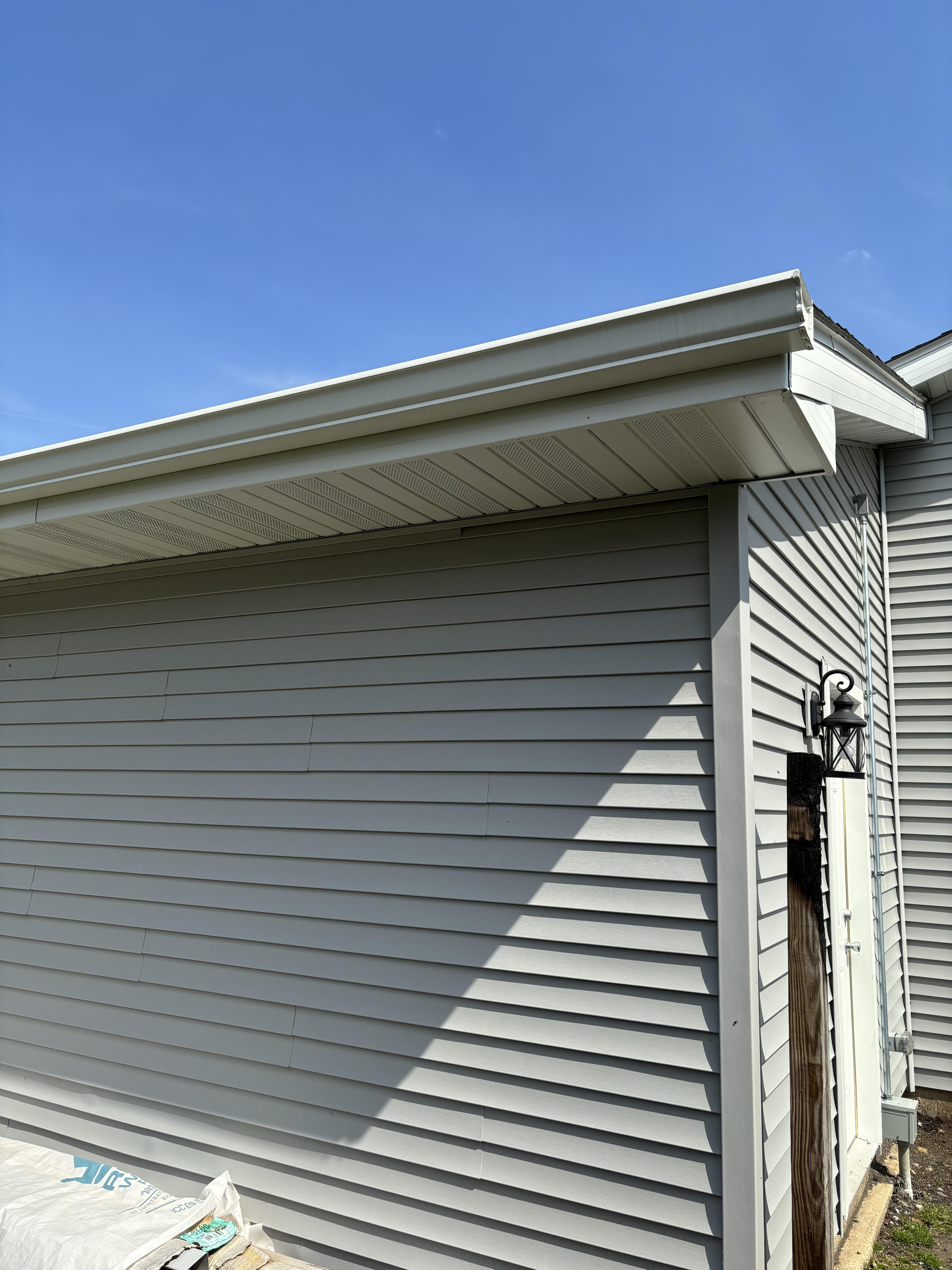 Freshly installed gutter system with downspouts on residential home